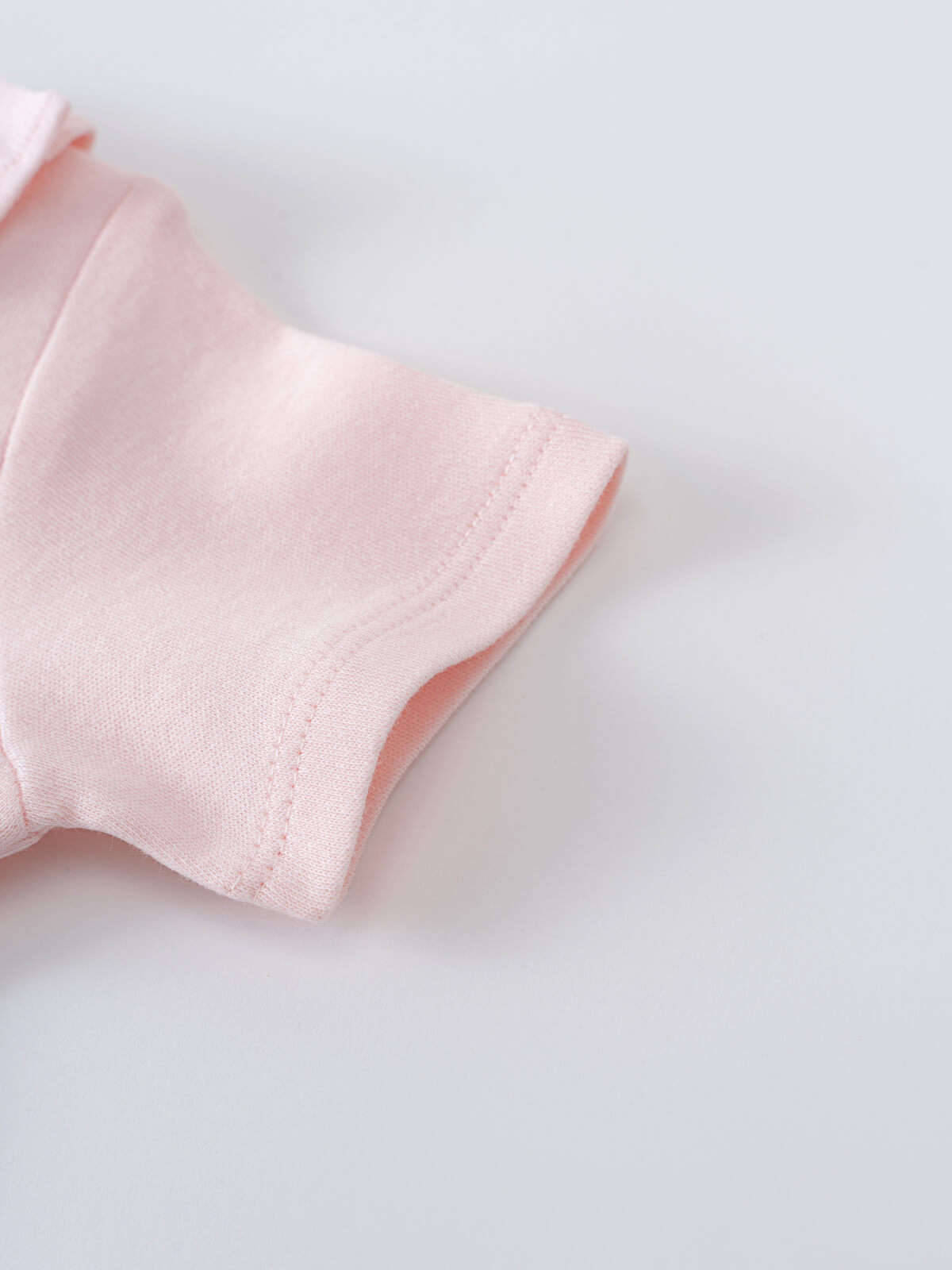 Close-up of a pale pink bodysuit sleeve with stitched seam detail Olivia Short Sleeve Bodysuit - Candy Floss Baby girl