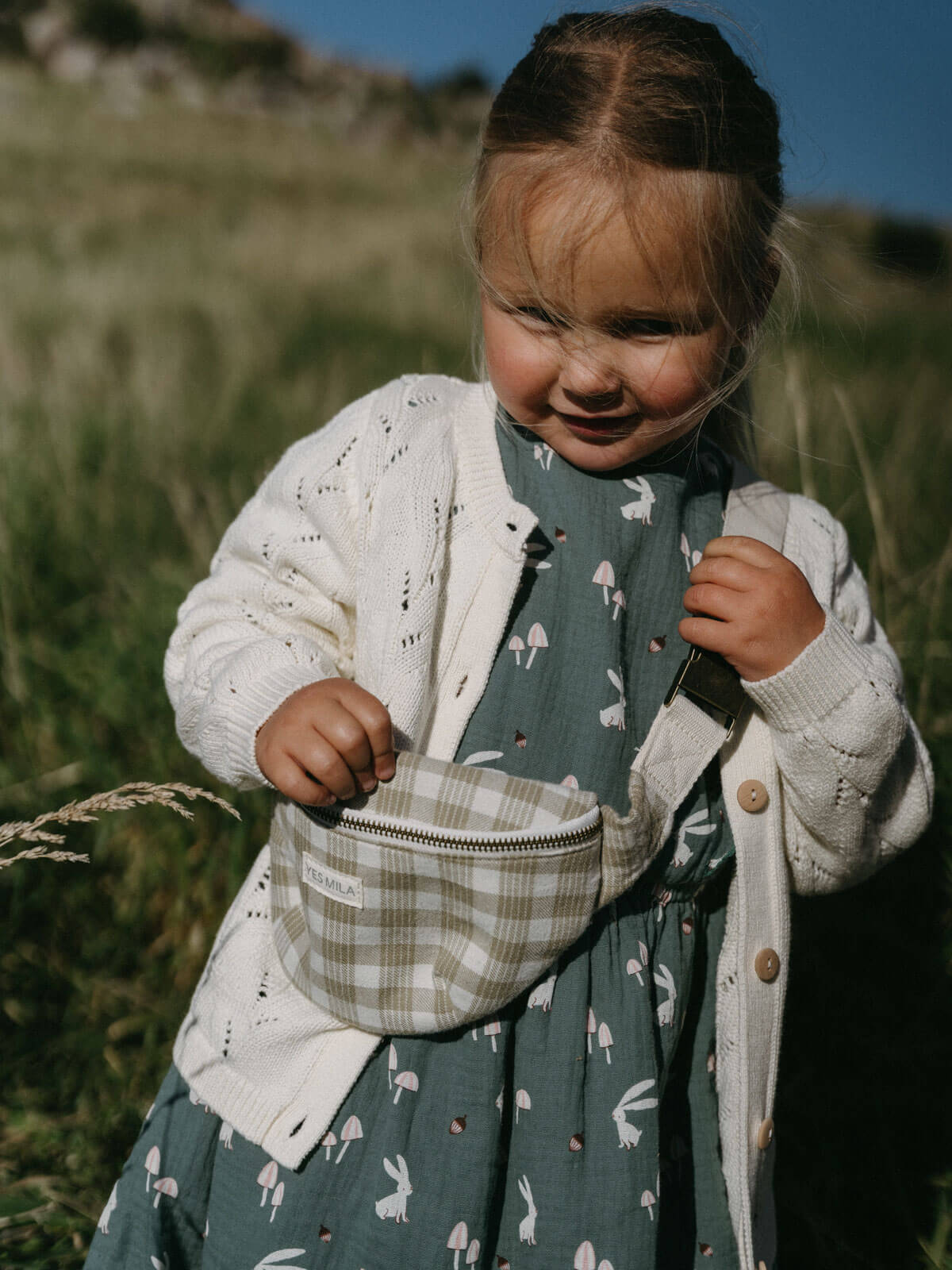 Child holding a small bag in a grassy outdoor setting Crossbody Bag - Brushed Cotton Check Girls and Boys