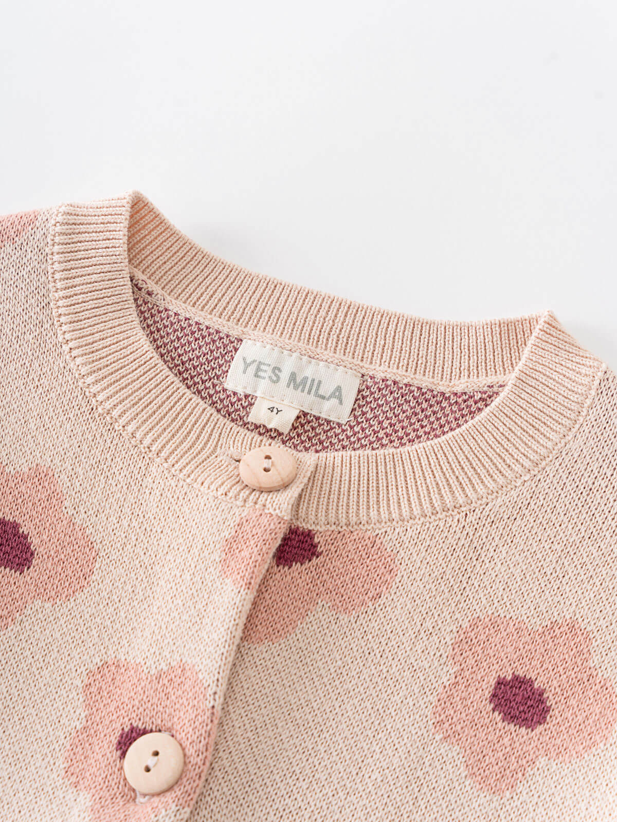 Pink knitted cardigan with floral patterns and button details on a white background Printed Cardigan - Bold Daisy Girls