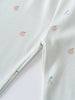 White fabric with small embroidered peach pattern, showing fold and texture Printed Leggings - Summer Fruits Girls