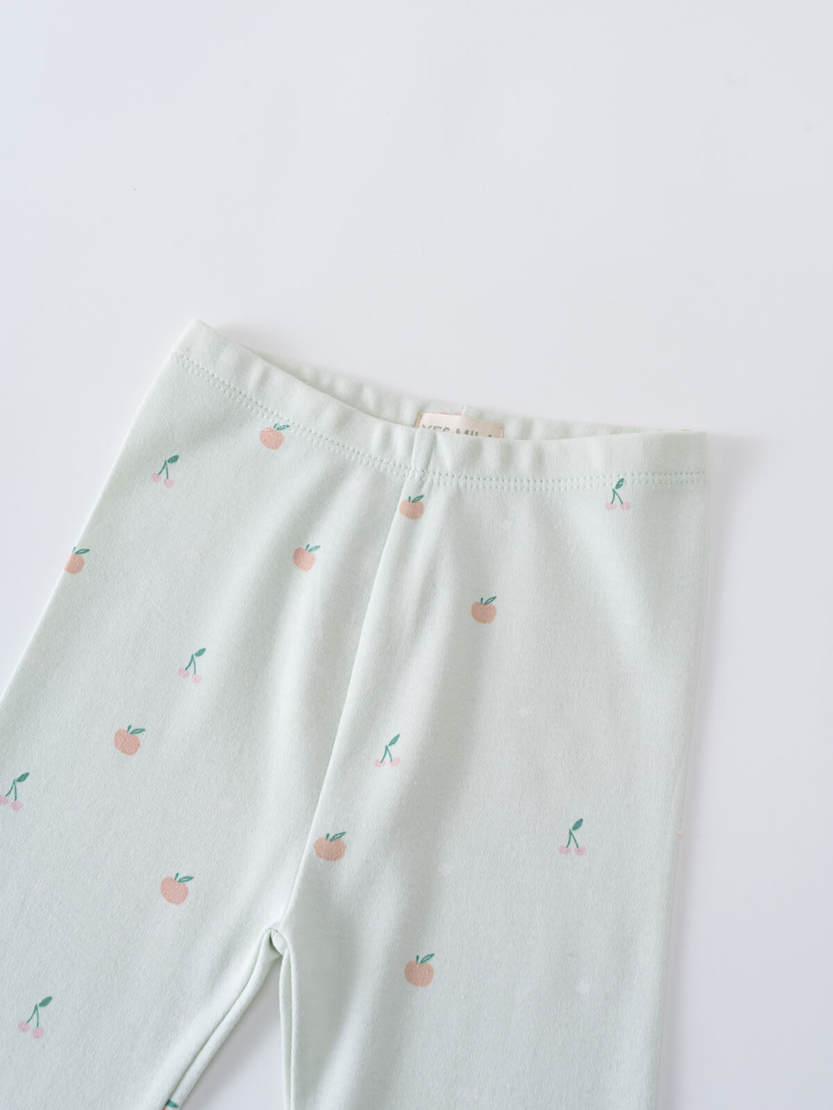Close-up of pale mint leggings with small peach fruit pattern Leggings - Summer Fruits Girls