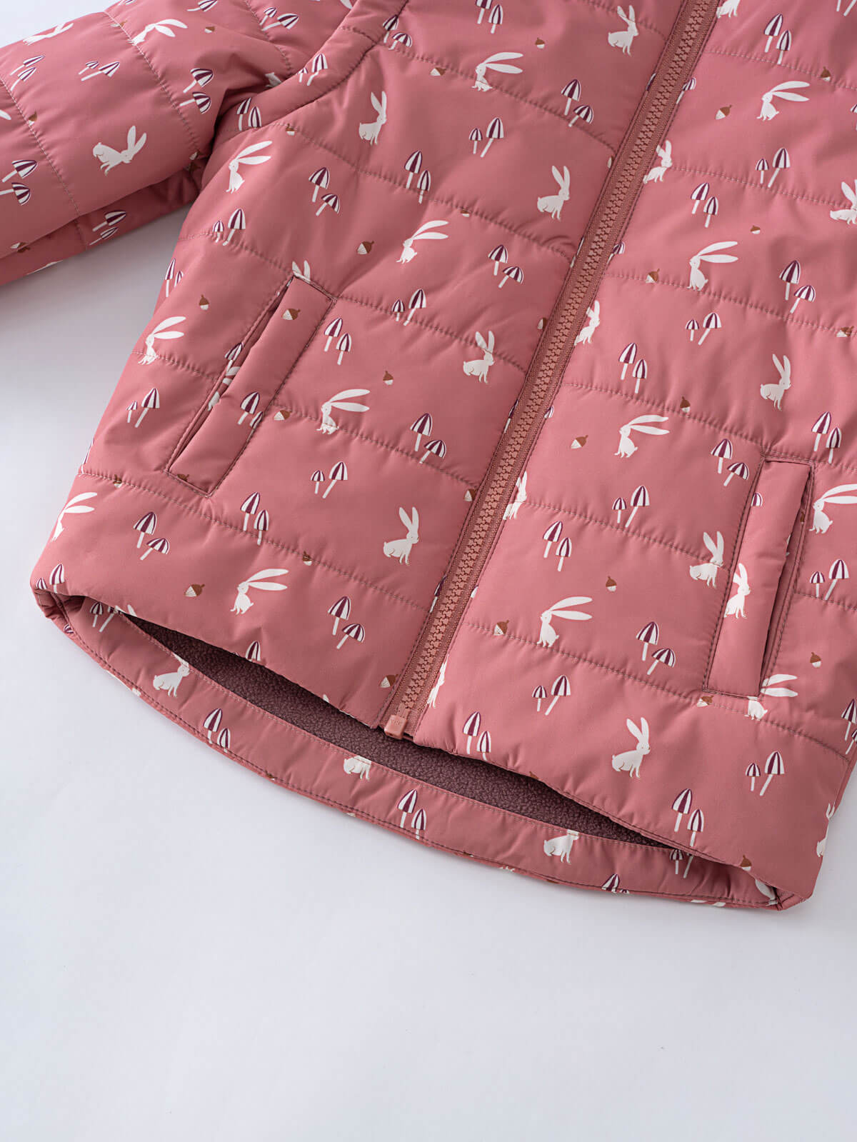 Close-up of quilted pink vest with white bunny print and pockets Printed Puffer Vest Jacket - Forest Gathering Rosehip Girls