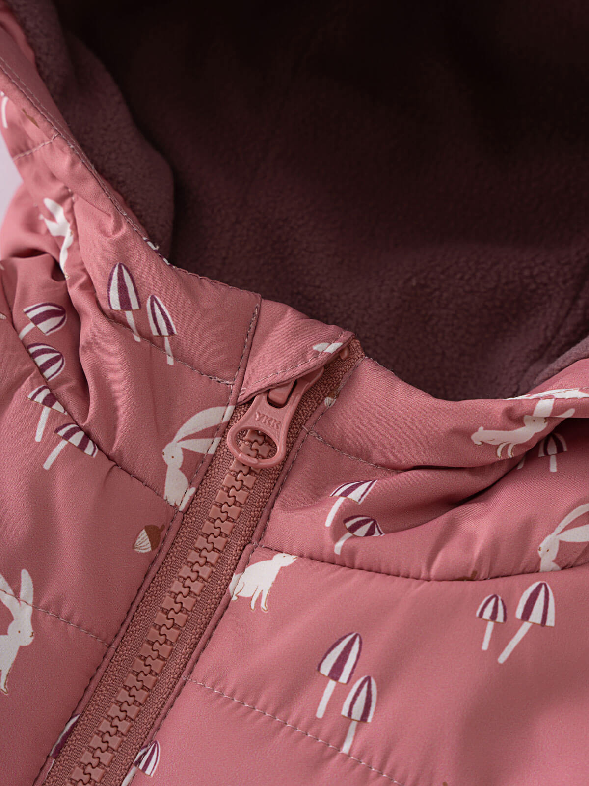 Close-up of pink puffer vest zipper with white rabbit and mushroom print Printed Puffer Vest Jacket - Forest Gathering Rosehip Girls