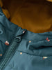 Close-up of a teal puffer vest with small printed pattern and zipper Printed Puffer Vest Jacket - Mountain View Balsam Boys