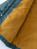 Close-up of mustard fleece lining inside a teal printed puffer vest Printed Puffer Vest Jacket - Mountain View Balsam Boys