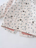 Close-up of a floral printed raincoat with snap buttons and pockets Printed Raincoat - Wild Flowers Ecru Girls