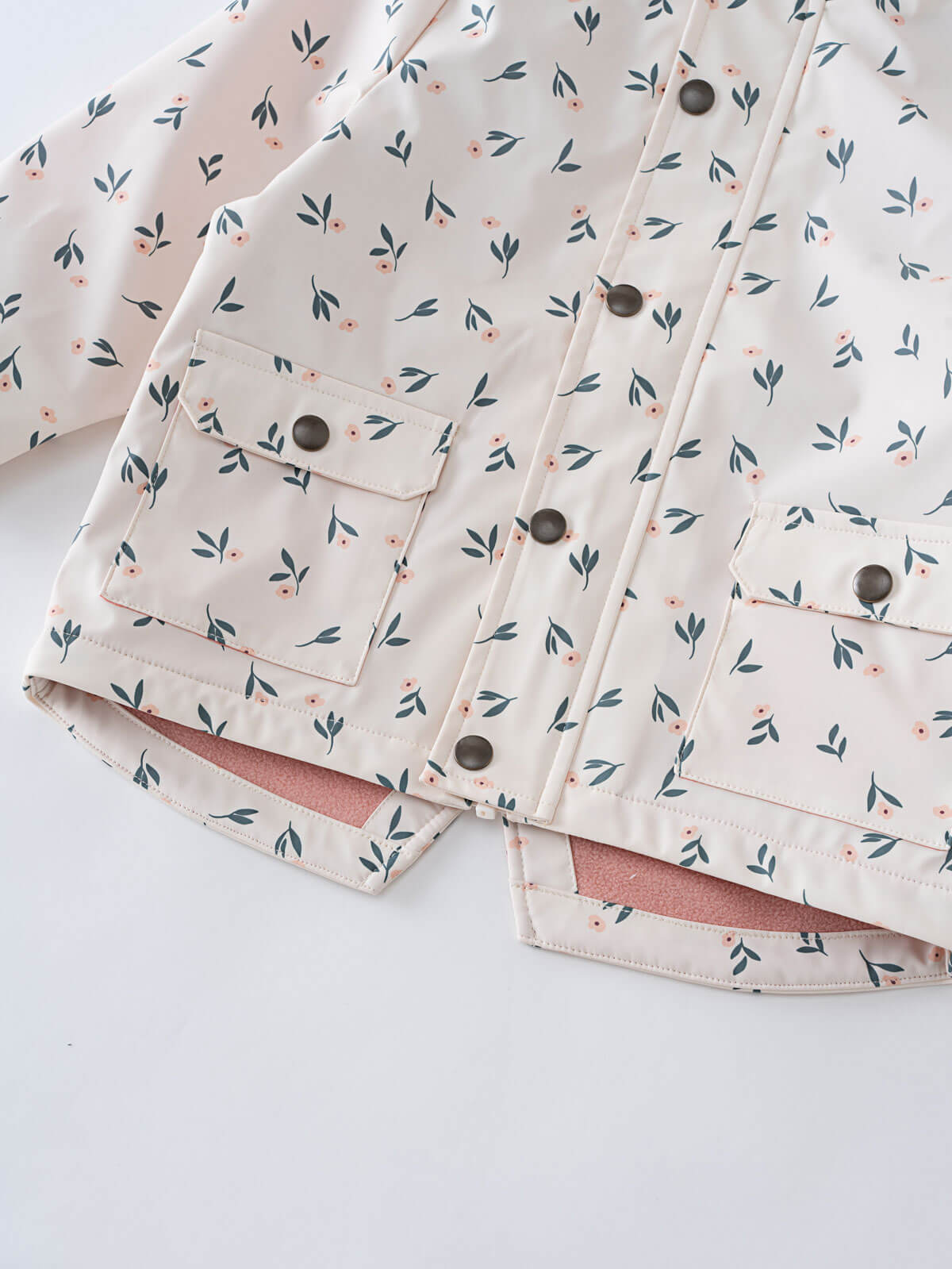 Close-up of a floral printed raincoat with snap buttons and pockets Printed Raincoat - Wild Flowers Ecru Girls