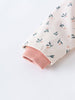 Close-up of a white floral-printed sleeve with pink ribbed cuff Printed Raincoat - Wild Flowers Ecru Girls