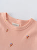 Close-up of a peach-colored t-shirt collar with small ice cream cone prints Printed Short Sleeve Tee Shirt - Ice Creams Girls