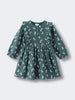 Green dress with animal pattern on a light gray background