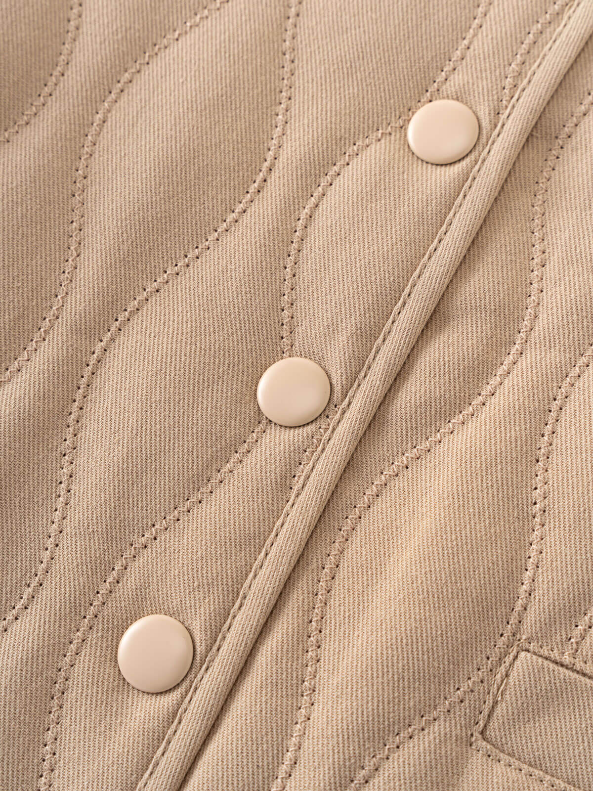Close-up of a beige quilted jacket with button details Quilted Jacket - Clay Baby girl