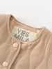 Close-up of a beige garment with a 'YES MILA' label on a white background Quilted Jacket - Clay Baby girl