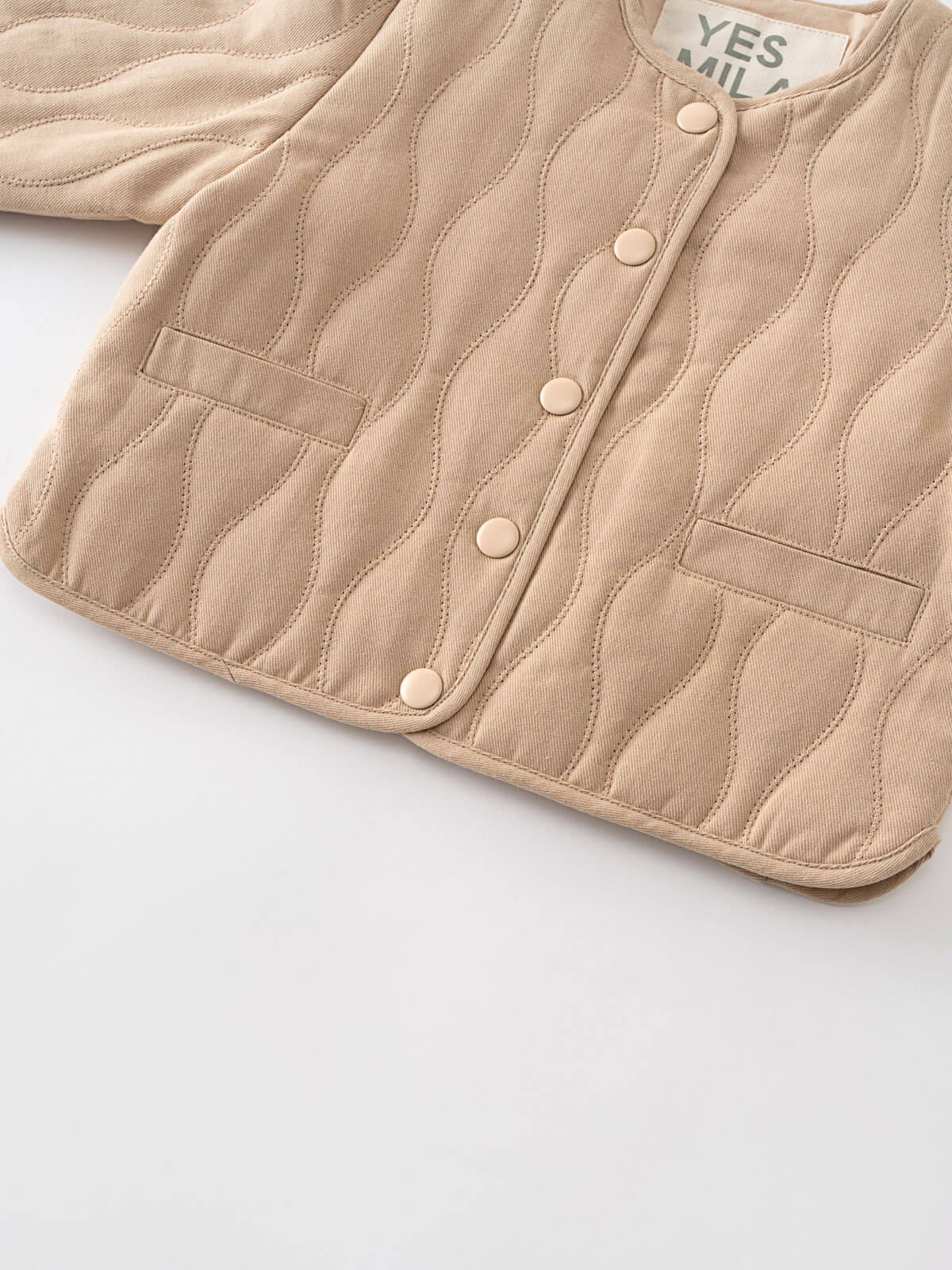 Beige quilted jacket with button details on a light gray background Quilted Jacket - Clay Baby girl