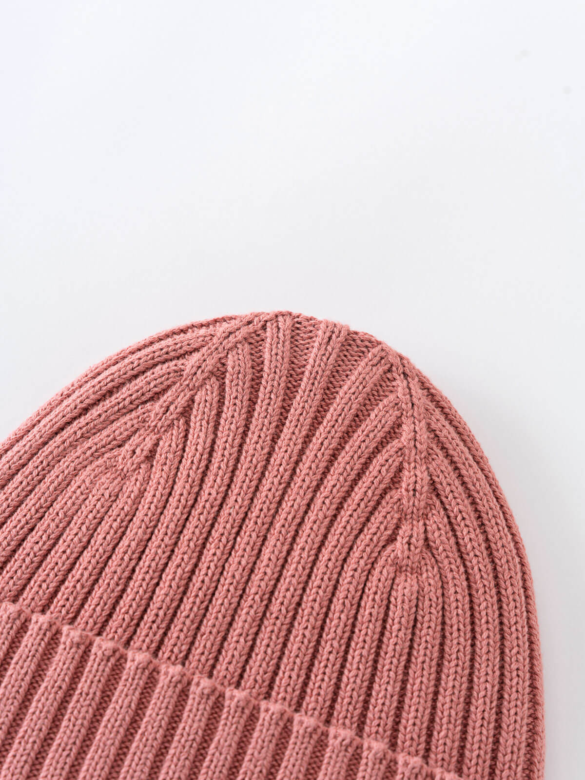 Close-up of a pink knitted beanie on a light gray background Ribbed Beanie - Rosehip Girls