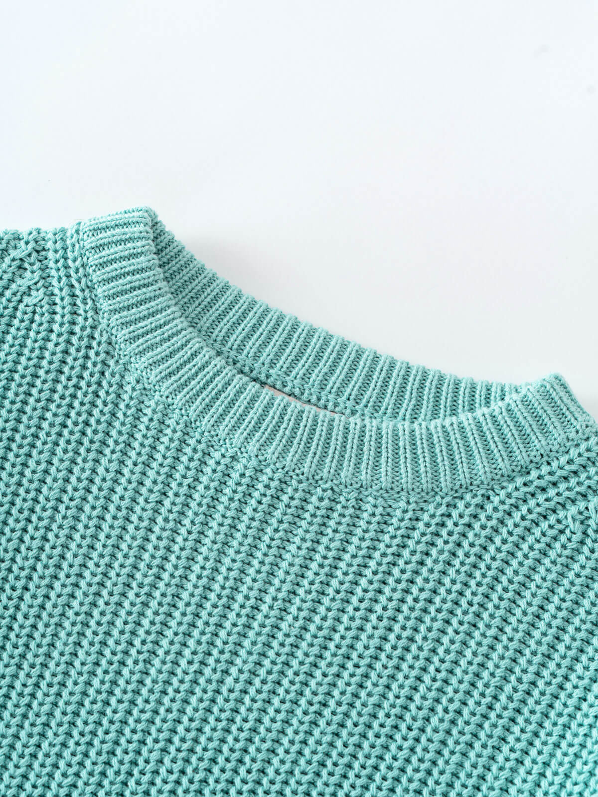 Lake blue sweater on a light blue background