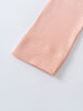 Close-up of ribbed peach fabric with a finished hemmed edge Ribbed Leggings - Toasted Peach Girls