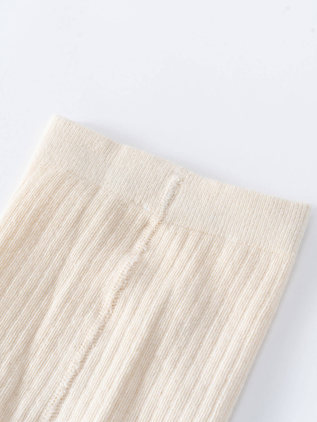 Close-up of cream colored ribbed knit fabric with vertical seam detail Ribbed Tights 2 Pack - Golden Pear/Ecru Girls