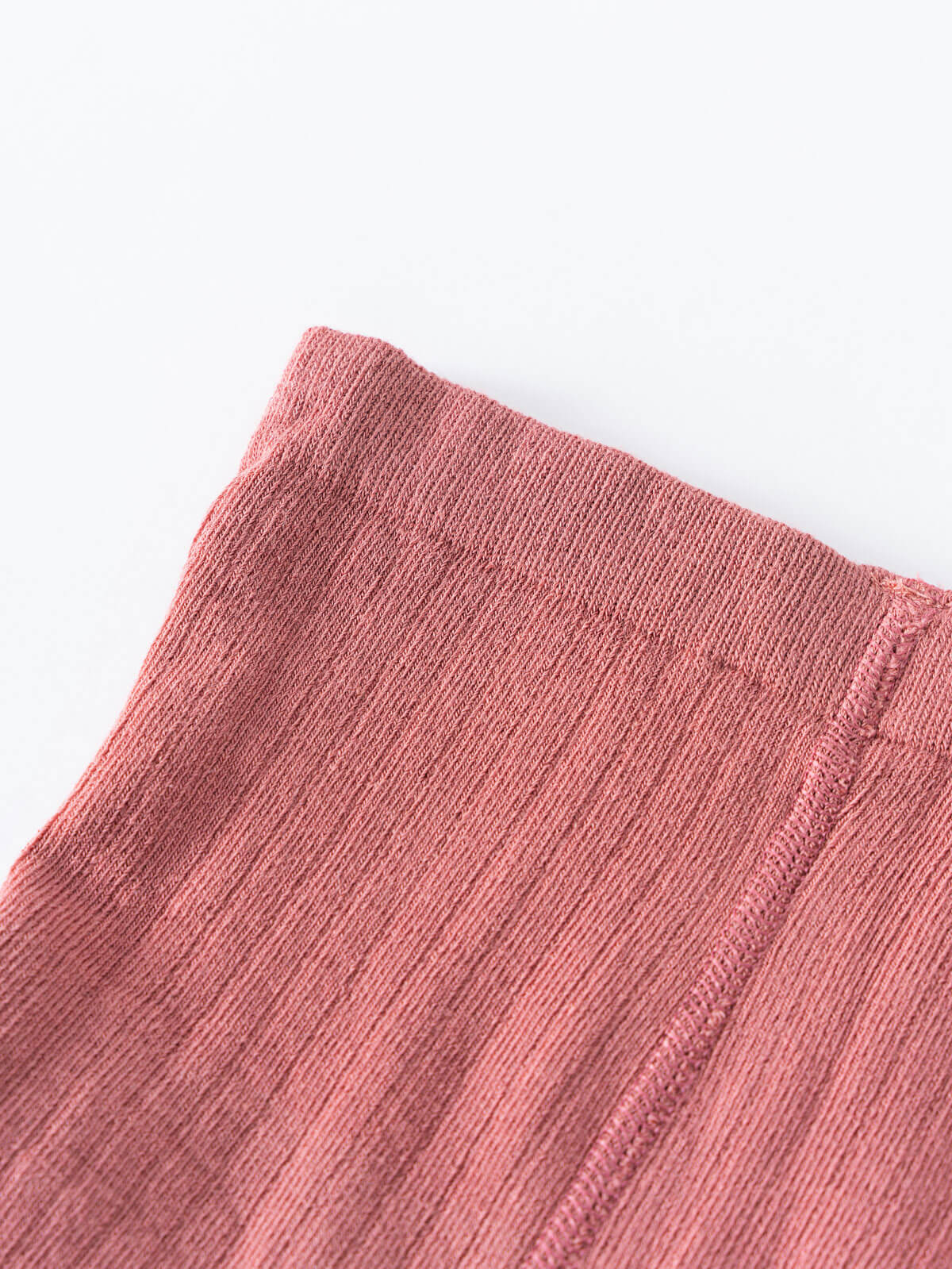 Close-up of pink ribbed knit fabric with diagonal texture and finished edge Ribbed Tights 2 Pack - Rosehip/Russet Girls