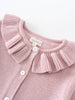 Close-up of a pink ribbed knit cardigan with ruffled collar and white buttons Ruffle Cardigan - Blush Girls
