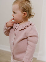 Young child wearing a pink knit cardigan with ruffle collar detail Ruffle Cardigan - Blush Girls
