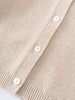 Close-up of a beige knitted cardigan with white buttons on a light gray background Ruffle Cardigan - Ecru Girls