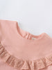 Close-up of a pink blouse with a ruffled collar on a light gray background Ruffle Top - Mallow Girls