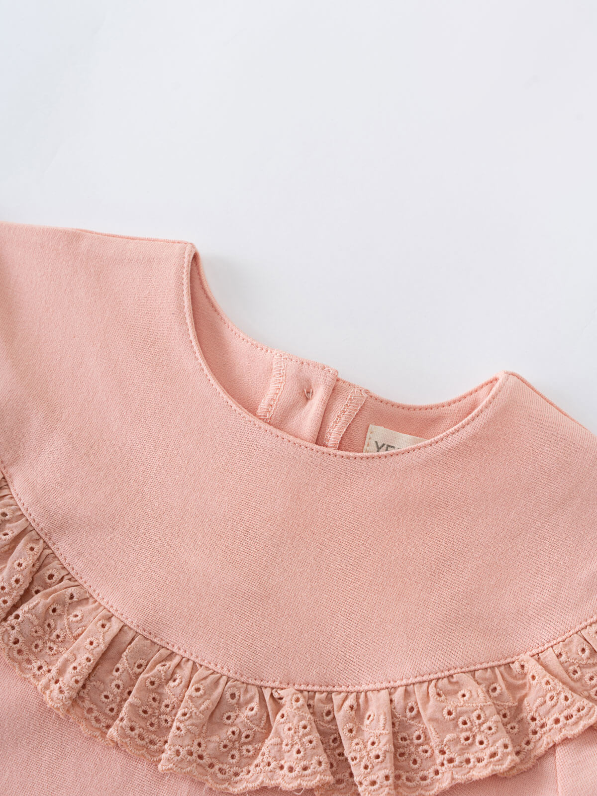 Close-up of a pink blouse with a ruffled collar on a light gray background Ruffle Top - Mallow Girls