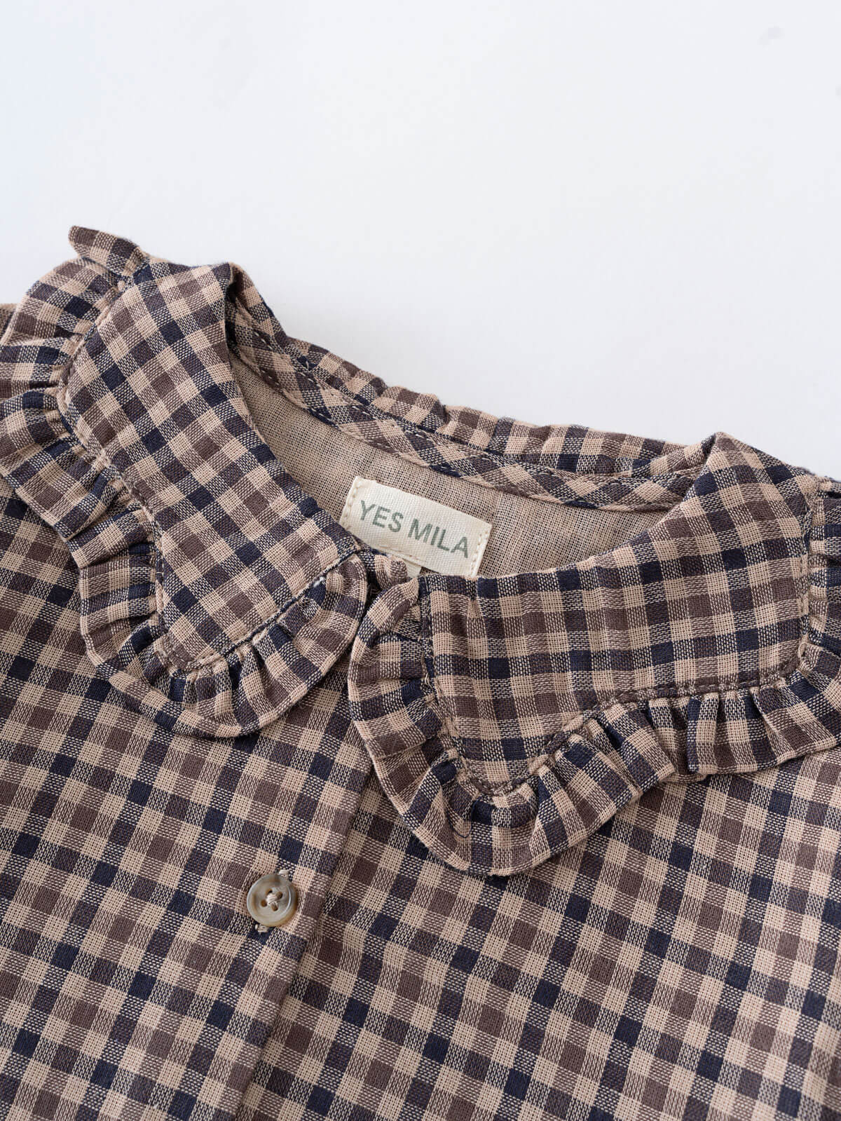 Plaid shirt with ruffled collar and 'YES MILA' label on a white background Ruffle Woven Blouse - Muslin Cotton Check Girls