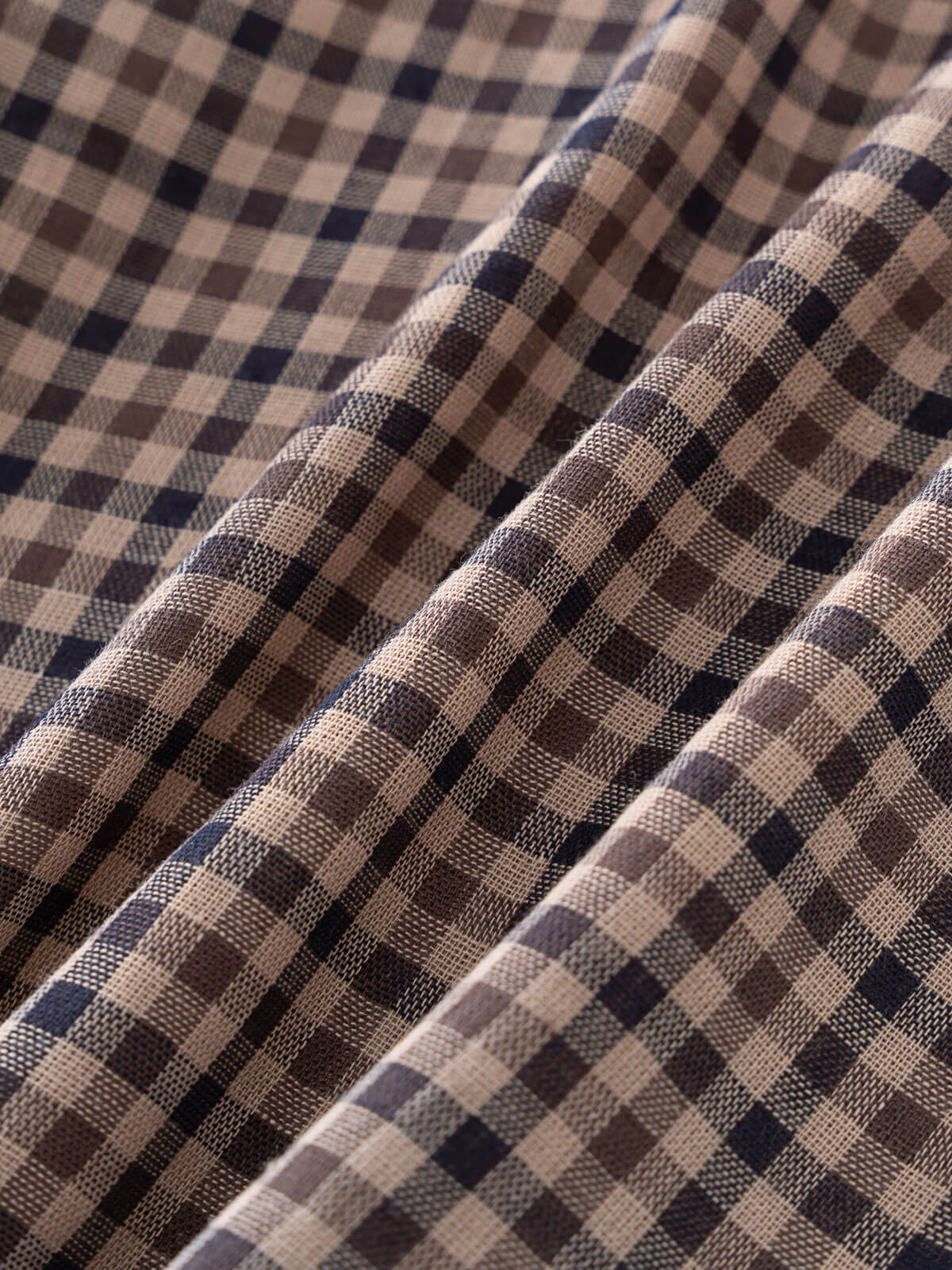 Close-up of checkered fabric with brown, beige, and blue pattern Ruffle Woven Blouse - Muslin Cotton Check Girls