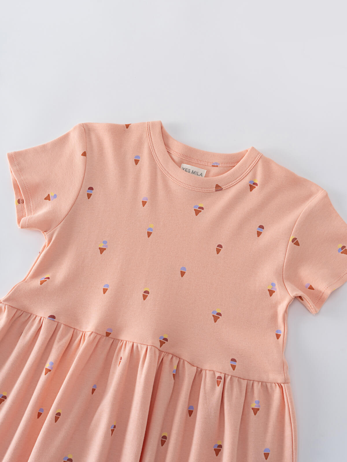 Close-up of a peach-colored dress with small ice cream cone print Short Sleeve Dress - Ice Creams Girls