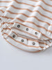 Close-up of striped fabric with metal snap closures at bottom Sleeveless Romper - Sand Stripe Baby boy