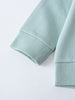 Close-up of light blue sweatshirt sleeve showing ribbed cuff detail Sophie Sweatshirt - Posy Mint Girls