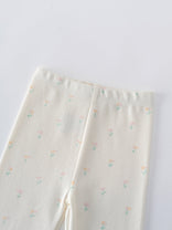 Close-up of cream-colored baby leggings with small pastel floral print Stella Leggings - Spring Bloom Baby girl