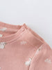 Close-up of pink knitted fabric with white animal pattern and button detail Baby Sweatshirt Dress - Meadow Friends Blush Baby girl
