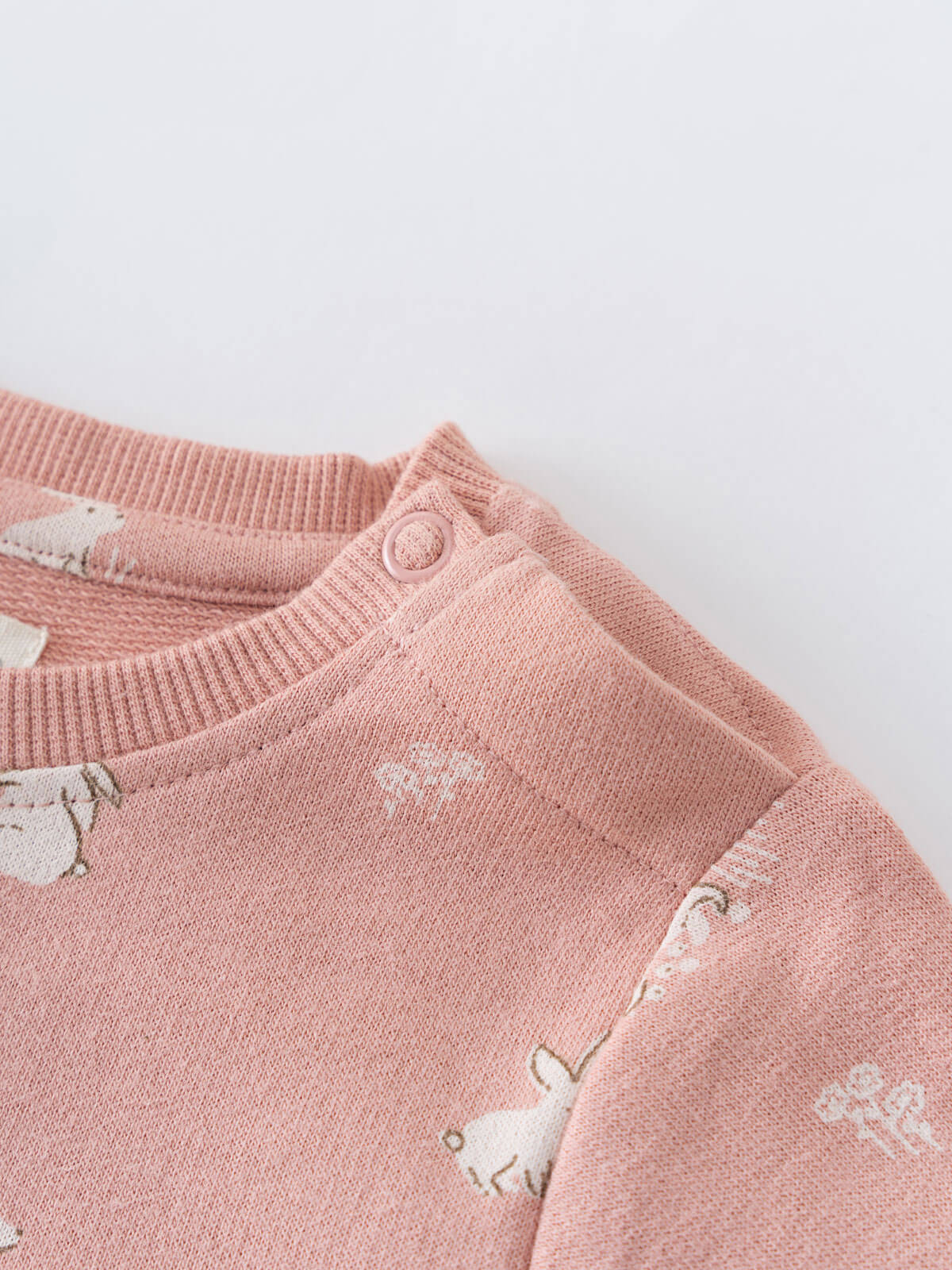 Close-up of pink knitted fabric with white animal pattern and button detail Baby Sweatshirt Dress - Meadow Friends Blush Baby girl