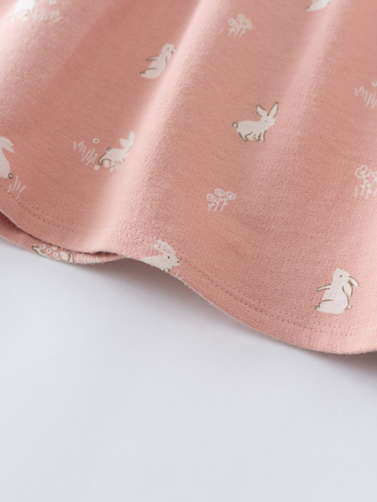 Close-up of pink fabric with white rabbit and flower print pattern Baby Sweatshirt Dress - Meadow Friends Blush Baby girl
