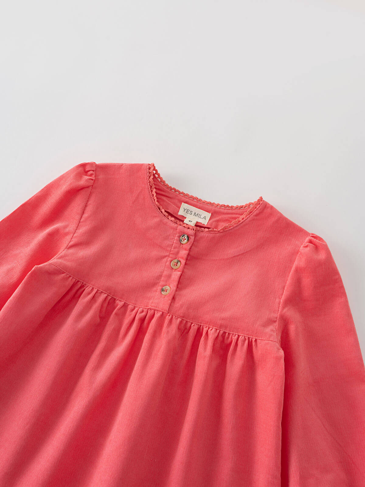 Pink blouse with long sleeves with a label on a light gray background Three Button Blouse - Cloudberry Girls