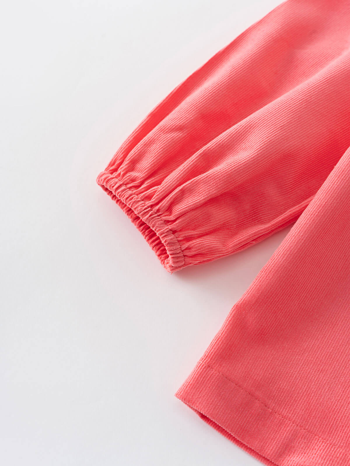 Close-up of coral pink blouse on a light gray background Three Button Blouse - Cloudberry Girls