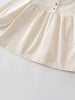 Close-up of a cream-colored blouse with buttons with a plain background Three Button Blouse - Ecru Girls