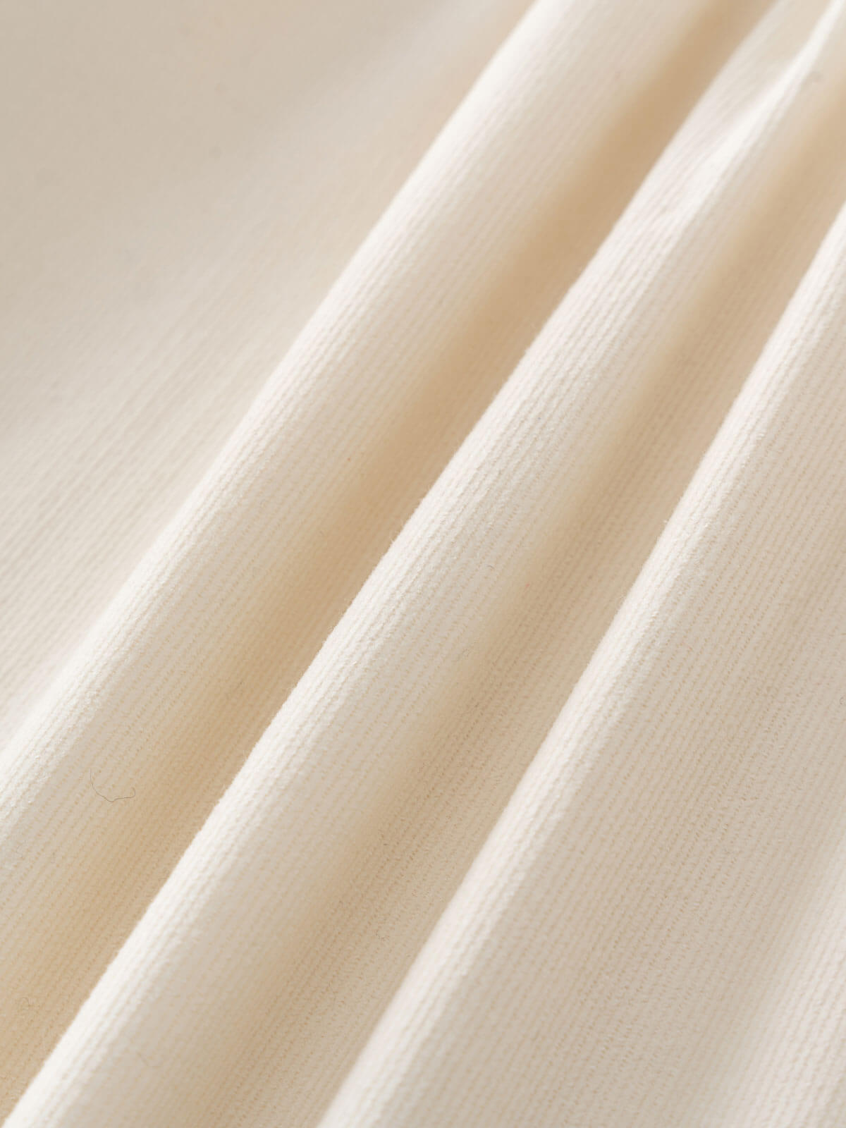 Close-up of beige fabric with a subtle texture Three Button Blouse - Ecru Girls