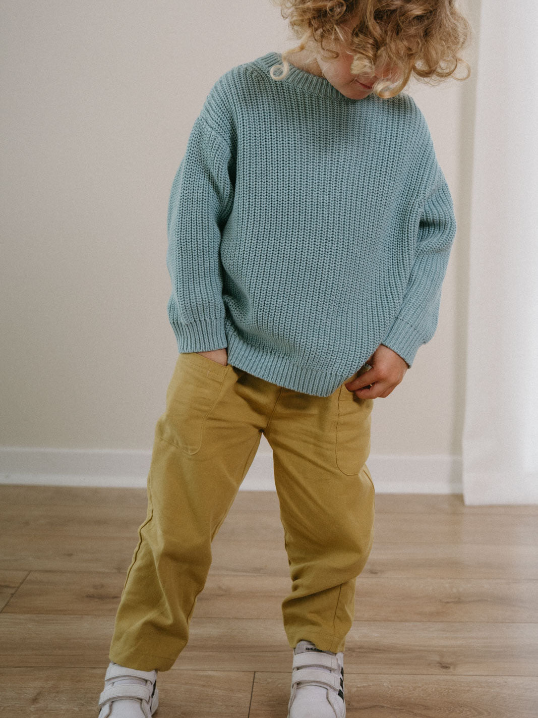Child wearing light blue knitted sweater and mustard yellow pants indoors Twill Pants - Golden Pear Boys