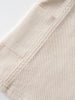 Close-up of cream-colored fabric with stitched seams and textured weave Twill Pinafore Dress - Salt Girls
