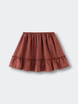 Rust-colored skirt with elastic waistband and ruffled hem on flat surface Woven Skirt - Rosehip Girls